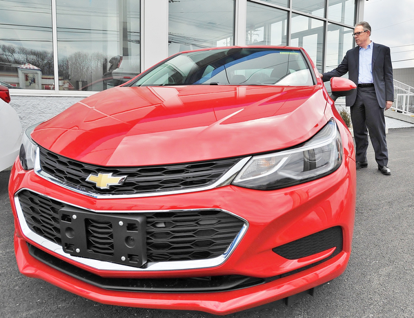 Jeff Lange | The Vindicator  WED, MAR 23, 2016 - Greg Greenwood shows off a brand new Chevy Cruze available at Greenwood Chevrolet in Austintown Wednesday afternoon.