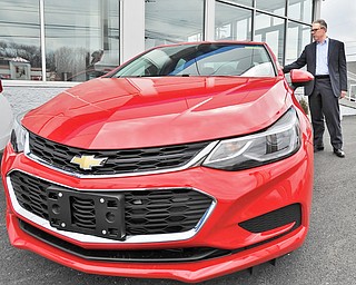 Jeff Lange | The Vindicator  WED, MAR 23, 2016 - Greg Greenwood shows off a brand new Chevy Cruze available at Greenwood Chevrolet in Austintown Wednesday afternoon.