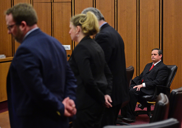 CLEVELAND, OHIO - MARCH 25, 2016: Attorney Martin Yavorcik sits at the defense table while Lead Prosecutor & Senior Asst. Ohio Attorney General Dan Kasaris, Leigh Bayer the Asst. Attorney General for Ohio and Matthew E. Meyer the Cuyahoga County Asst. Prosecutor speak to the judge during court proceeding Friday afternoon at the Cleveland Municipal Court. DAVID DERMER | THE VINDICATOR