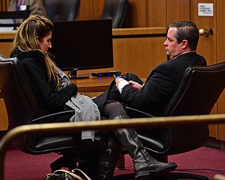 CLEVELAND, OHIO - MARCH 25, 2016: Attorney Martin Yavorcik talks with his girlfriend at the defense table after court proceeding Friday afternoon at the Cleveland Municipal Court. DAVID DERMER | THE VINDICATOR