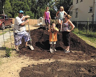SPECIAL TO THE VINDICATOR | Trumbull Neighborhood Partnership has named the recipients of the ServeOhio 2016 Service Award for the Northeast Ohio region. They are Neil and Jennifer Hockman. Above, shown working on the Good Looking View Children’s Garden are the Hockmans and their children. In front from left are Neil, Christian and Jennifer Hockman. Standing on the hill are Breana and Makenzie Hockman.