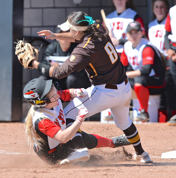 Jeff Lange | The Vindicator  SAT, MAR 26, 2016 - Youngstown State University baserunner Sarah Dowd (bottom) collides with Valpo third baseman Stephanie Moreno (8) as she safely steals third base in the first inning of game two of Saturday's double header in Youngstown.
