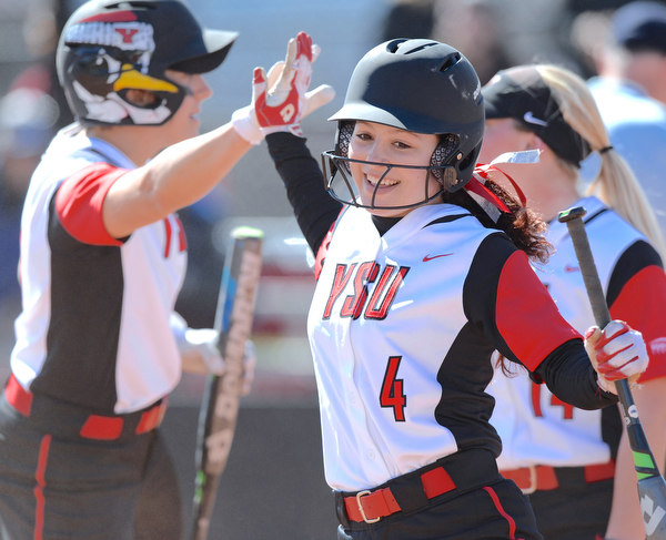 Jeff Lange | The Vindicator  SAT, MAR 26, 2016 - Youngstown's Cali Mikovich (4) celebrates with teammates after her home run in the third inning of the Penguins' second game against Valparaiso Saturday afternoon in Youngstown.