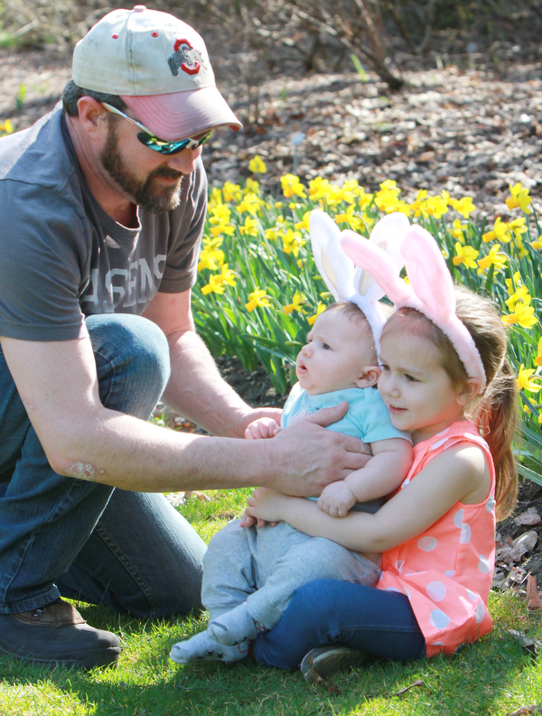 William D Lewis the vindicator  Richard Stuntz of Austintown situates his children Oliver, 3 months and Magnolia, 4, in Fellows Riverside Gardens while his wife Carrie Stuntz(not in pix) prepares to snap a photo Sunday 3-27-26