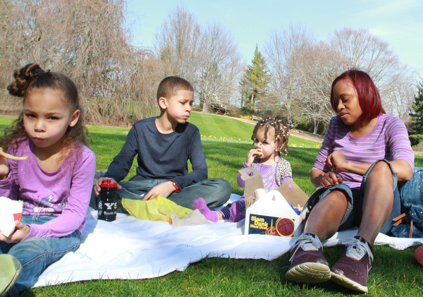 William D Lewis the Vindicator Lillian Evans of Youngsotwn and her children From left, Shayla, 6, Malik, 10 and Mya , 2, hve a picnic lunch at Fellows Riverside Gardens in Mill Creek Park 3-27-16.