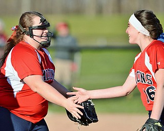 Jeff Lange | The Vindicator  TUE, MAR 29, 2016 - Fitch's Alex Franken (left) celebrates with second baseman Maddie Everhart after putting out a Poland baserunner during Tuesday afternoon's game in Poland.