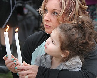 William D Lewis the vindicator  Vigil on Powers Way 3/30/16 for Corinne Gump and her grandparents who died in a fire 1 year ago. Lee Ann Reda of Struthers, aunt of Corinne Gump, and her grandaughter Adele Viera, 2, light candles during the vigil.