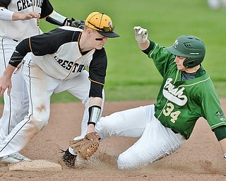 Jeff Lange | The Vindicator  WED, MAR 30, 2016 - Crestview's Caleb Hill (left) puts the tag on Ursuline base runner Logan Pullin (34) as he slides into second base late in Wednesday's game in Struthers.