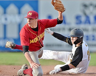 Jeff Lange | The Vindicator  THU, MAR 31, 2016 - Mooney second baseman Jack Lynch (left) looks to the official for the call as Crestview's Tyler Hurd slides safely into second in the seventh inning of Thursday's game in Struthers.