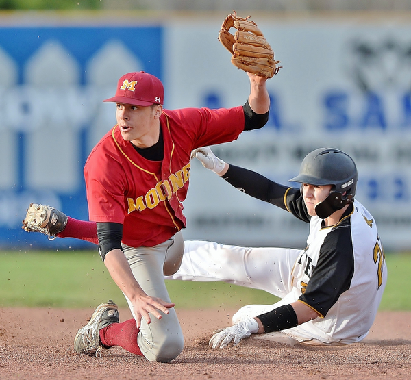 Jeff Lange | The Vindicator  THU, MAR 31, 2016 - Mooney shortstop Bryce Richey (left) looks to the official for the call as Crestview's Tyler Hurd slides safely into second in the seventh inning of Thursday's game in Struthers.