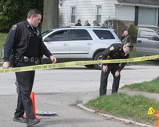      ROBERT K. YOSAY  | THE VINDICATOR..YPD officers look for evidence on Maywood and Erie.."Members of the US Marshals Northern Ohio Violent Fugitive Task Force were actively searching for Luis R Cruz-Ramos," said Capt. Brad Blackburn in the news release. "He was spotted walking near the 200 block of Lowell Avenue. He fled toward Maywood, holding a handgun as the task force attempted to apprehend him." - .--30-...