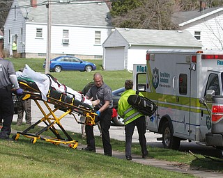      ROBERT K. YOSAY  | THE VINDICATOR..Rural Metro paramedics move Ramos to the waiting ambulance.."Members of the US Marshals Northern Ohio Violent Fugitive Task Force were actively searching for Luis R Cruz-Ramos," said Capt. Brad Blackburn in the news release. "He was spotted walking near the 200 block of Lowell Avenue. He fled toward Maywood, holding a handgun as the task force attempted to apprehend him." - .--30-...