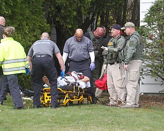      ROBERT K. YOSAY  | THE VINDICATOR..Ramos on Stretcher as they prepare to move him from  where he was shot behind a hoss on Maywood. near erie .."Members of the US Marshals Northern Ohio Violent Fugitive Task Force were actively searching for Luis R Cruz-Ramos," said Capt. Brad Blackburn in the news release. "He was spotted walking near the 200 block of Lowell Avenue. He fled toward Maywood, holding a handgun as the task force attempted to apprehend him." - .--30-...