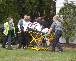      ROBERT K. YOSAY  | THE VINDICATOR..Rural Metro paramedics move Ramos to the waiting ambulance.."Members of the US Marshals Northern Ohio Violent Fugitive Task Force were actively searching for Luis R Cruz-Ramos," said Capt. Brad Blackburn in the news release. "He was spotted walking near the 200 block of Lowell Avenue. He fled toward Maywood, holding a handgun as the task force attempted to apprehend him." - .--30-...