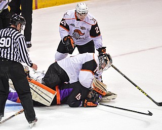 YOUNGSTOWN, OHIO - APRIL 1, 2016: Goalie Zacharias Skog #1 of Omaha takes a swing at Matt Alvaro #19 of the Phantoms after he was tripped and slid into him on a break away during the 1st period of Friday nights game at the Corelli Centre. DAVID DERMER | THE VINDICATOR..Nathan Krusko #26 of Omaha pictured.