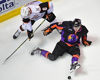 YOUNGSTOWN, OHIO - APRIL 1, 2016: Cameron Morrison #26 of the Phantoms falls to the ice after being taken down by Nick Jenny #6 of Omaha during the 2nd period of Friday nights game at the Corelli Centre. DAVID DERMER | THE VINDICATOR