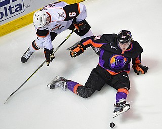 YOUNGSTOWN, OHIO - APRIL 1, 2016: Cameron Morrison #26 of the Phantoms falls to the ice after being taken down by Nick Jenny #6 of Omaha during the 2nd period of Friday nights game at the Covelli Centre. DAVID DERMER | THE VINDICATOR