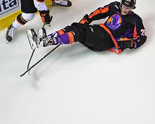 YOUNGSTOWN, OHIO - APRIL 1, 2016: Cameron Morrison #26 of the Phantoms falls to the ice after being taken down by Nick Jenny #6 of Omaha during the 2nd period of Friday nights game at the Corelli Centre. DAVID DERMER | THE VINDICATOR