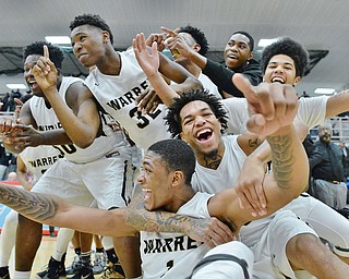 Jeff Lange | The Vindicator  MON, MAR 2, 2016 - Warren G. Harding team leaders Derek Culver (bottom) and Lynn Bowden (center) celebrate with teammates after the Raiders defeated Louisville, 62-58, to advance to the Division I district championship Wednesday, March 2, 2016 at Alliance High School.