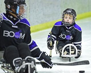 BOARDMAN, OHIO - APRIL 2, 2016: Kellan Shipman #90 of the Youngstown Boom looks looks to Casey Followay #4 after passing him the puck during a Adaptive Sled Ice Hockey charity game against the Youngstown Phantoms Bantam A Team Saturday afternoon at the Ice Zone. DAVID DERMER | THE VINDICATOR