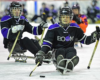 BOARDMAN, OHIO - APRIL 2, 2016: Jacob Baker #87 of the Youngstown Boom skates with the puck on his way to the net during a Adaptive Sled Ice Hockey charity game against the Youngstown Phantoms Bantam A Team Saturday afternoon at the Ice Zone. DAVID DERMER | THE VINDICATOR