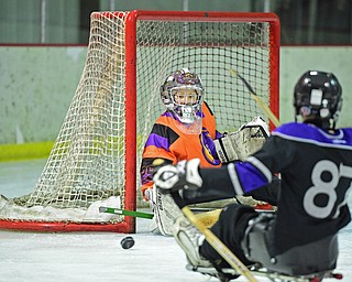 BOARDMAN, OHIO - APRIL 2, 2016: Sophie Bellina #29 of the Youngstown Phantoms Bantam A Team blocks the shot from Jacob Baker #87 of the Youngstown Boom during a Adaptive Sled Ice Hockey charity game against the Youngstown Boom Saturday afternoon at the Ice Zone. DAVID DERMER | THE VINDICATOR
