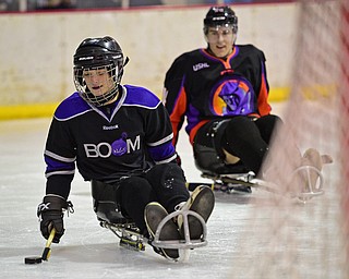 BOARDMAN, OHIO - APRIL 2, 2016: Jacob Baker #87 of the Youngstown Boom skates toward the net after getting behind James Winkler #14 of the Phantoms during a Adaptive Sled Ice Hockey charity game against the Youngstown Phantoms Bantam A Team Saturday afternoon at the Ice Zone. DAVID DERMER | THE VINDICATOR