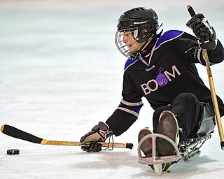 BOARDMAN, OHIO - APRIL 2, 2016: Jacob Baker #87 of the Youngstown Boom controls the puck in the offensive zone during a Adaptive Sled Ice Hockey charity game against the Youngstown Phantoms Bantam A Team Saturday afternoon at the Ice Zone. DAVID DERMER | THE VINDICATOR
