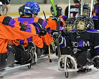 BOARDMAN, OHIO - APRIL 2, 2016: Joshua Kurth #6 of the Youngstown Boom gets a post game fist pump from Geoffrey Bokor #14 of the Youngstown Phantoms Bantam A Team after a Adaptive Sled Ice Hockey charity game against the Youngstown Phantoms Bantam A Team Saturday afternoon at the Ice Zone. DAVID DERMER | THE VINDICATOR