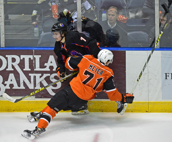 YOUNGSTOWN, OHIO - APRIL 2, 2016: Eric Esposito #7 of the Phantoms is checks into the boards by Matthew Meier #71 of the Lancers during the 1st period of Saturday nights game at the Corelli Centre. DAVID DERMER | THE VINDICATOR
