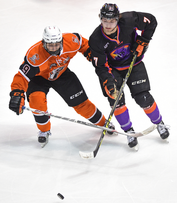 YOUNGSTOWN, OHIO - APRIL 2, 2016: Eric Esposito #7 of the Phantoms moves the puck up ice while being pressured by Patrick Harper #9 of the Lancers during the 1st period of Saturday nights game at the Corelli Centre. DAVID DERMER | THE VINDICATOR