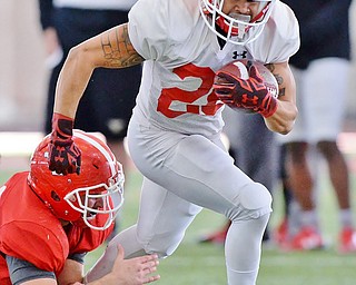 Jeff Lange | The Vindicator  SAT, APRIL 2, 2016 - YSU's Jodi Webb (20) sprints away from the tackle of Armand Dellovade during practice in Youngstown Saturday morning.
