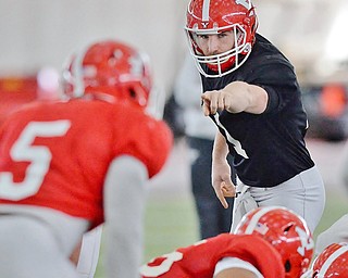 Jeff Lange | The Vindicator  SAT, APRIL 2, 2016 - YSU quarterback Trent Hosick points out linebacker Lee Wright (5) during practice in Youngstown Saturday morning.