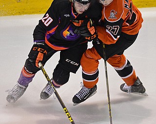 YOUNGSTOWN, OHIO - APRIL 2, 2016: Lukas Craggs #20 of the Phantoms and Jake Massie #27 of the Lancers battle for control of the puck in the neutral zone during the 1st period of Saturday nights game at the  Covelli Centre. DAVID DERMER | THE VINDICATOR