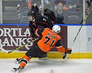 YOUNGSTOWN, OHIO - APRIL 2, 2016: Eric Esposito #7 of the Phantoms is checks into the boards by Matthew Meier #71 of the Lancers during the 1st period of Saturday nights game at the  Covelli Centre. DAVID DERMER | THE VINDICATOR