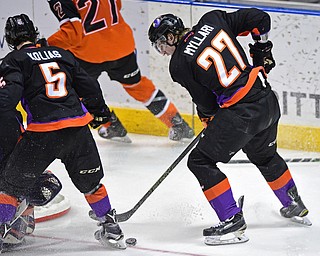 YOUNGSTOWN, OHIO - APRIL 2, 2016: Kris Myllari #27 of the Phantoms plays the puck after a deflected shot during the 3rd period of Saturday nights game at the  Covelli Centre. DAVID DERMER | THE VINDICATOR..Vas Kolias #5 of the Phantoms pictured.
