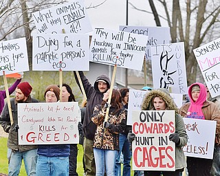 Jeff Lange | The Vindicator  MON, APRIL 4, 2016 - Animal rights activists gather with signs in hand to protest the opening of Candywood Whitetail Ranch in Vienna prior to the start of a town hall meeting in Vienna Township Monday evening.