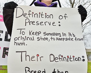 Jeff Lange | The Vindicator  MON, APRIL 4, 2016 - Erin Yale of Niles holds a sign during a protest against the opening of Candywood Whitetail Ranch Monday evening in Vienna.