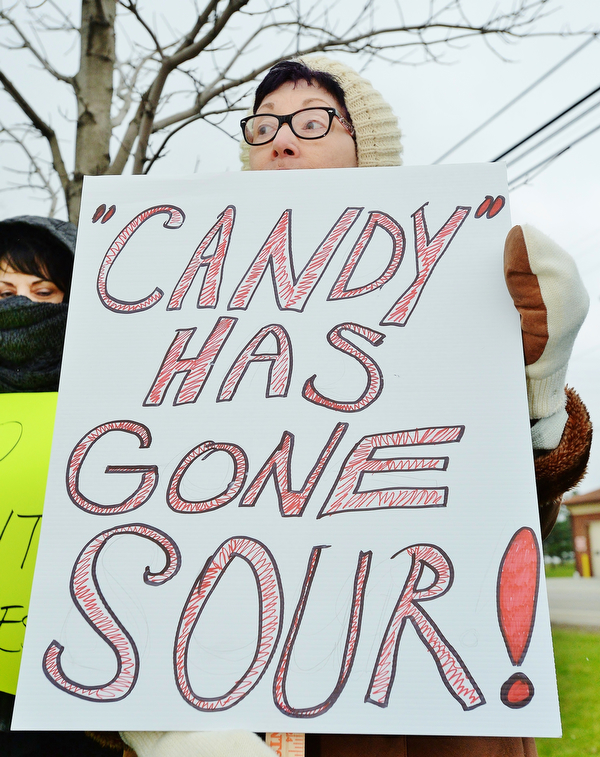 Jeff Lange | The Vindicator  MON, APRIL 4, 2016 - Cheryl Finta of Liberty holds a sign during a protest against the opening of Candywood Whitetail Ranch in Vienna Monday evening.