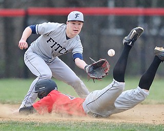 Jeff Lange | The Vindicator  WED, APRIL 6, 2016 - Fitch second baseman Kole Klasic looks to catch a throw from home as Canfield baserunner Alex Thompson dives safely into the bag in the first inning of Wednesday's game in Canfield.