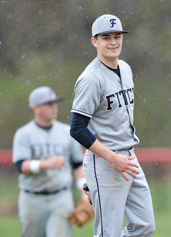 Jeff Lange | The Vindicator  WED, APRIL 6, 2016 - Fitch pitcher Derrick Gunther smiles back at the players in the dugout after catching a line drive sent back to the mound in the fifth inning of Wednesday's game at Canfield High School.