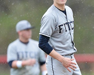 Jeff Lange | The Vindicator  WED, APRIL 6, 2016 - Fitch pitcher Derrick Gunther smiles back at the players in the dugout after catching a line drive sent back to the mound in the fifth inning of Wednesday's game at Canfield High School.