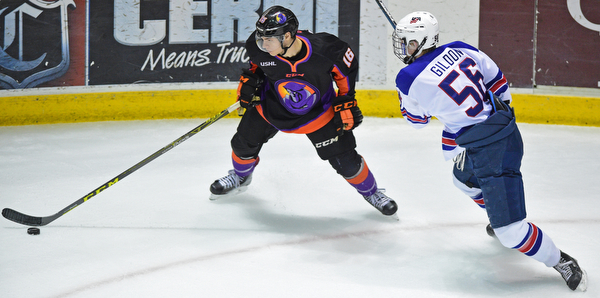 YOUNGSTOWN, OHIO - APRIL 9, 2016: Noah Lalonde #16 of the Phantoms plays the puck in the corner while being pressured by Max Gildon #56 of Team USA during the first period of Saturday nights game at the Corelli Centre. DAVID DERMER | THE VINDICATOR