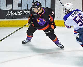 YOUNGSTOWN, OHIO - APRIL 9, 2016: Noah Lalonde #16 of the Phantoms plays the puck in the corner while being pressured by Max Gildon #56 of Team USA during the first period of Saturday nights game at the Corelli Centre. DAVID DERMER | THE VINDICATOR