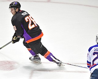YOUNGSTOWN, OHIO - APRIL 9, 2016: Connor Moore #28 of the Phantoms skates with the puck while being trailed by Keenan Suthers #27 of Team USA during the first period of Saturday nights game at the Corelli Centre. DAVID DERMER | THE VINDICATOR