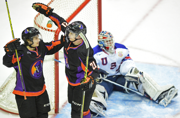 YOUNGSTOWN, OHIO - APRIL 9, 2016: Tommy Apap #21 of the Phantoms celebrates with teammate Eric Esposito #7 after scoring the third Phantoms goal of the game while Adam Scheel #31 of Team USA sits on the ice in frustration during the first period of Saturday nights game at the Corelli Centre. DAVID DERMER | THE VINDICATOR