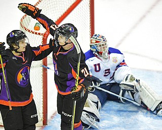 YOUNGSTOWN, OHIO - APRIL 9, 2016: Tommy Apap #21 of the Phantoms celebrates with teammate Eric Esposito #7 after scoring the third Phantoms goal of the game while Adam Scheel #31 of Team USA sits on the ice in frustration during the first period of Saturday nights game at the Corelli Centre. DAVID DERMER | THE VINDICATOR