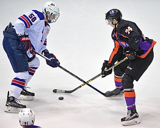 YOUNGSTOWN, OHIO - APRIL 9, 2016: Jason Cottom #24 of the Phantoms plays the puck while being pressured by Max Gildon #56 of Team USA during the first period of Saturday nights game at the Corelli Centre. DAVID DERMER | THE VINDICATOR