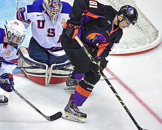 YOUNGSTOWN, OHIO - APRIL 9, 2016: Garrett Hall #81 of the Phantoms plays the puck by the net while being guarded by Dylan St. Cyr #33 and Quinn Hughes #43 of Team USA during the second period of Saturday nights game at the Corelli Centre. DAVID DERMER | THE VINDICATOR