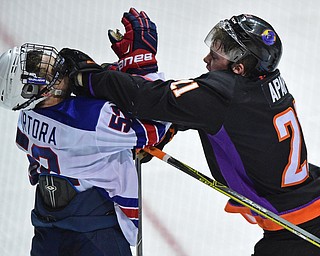 YOUNGSTOWN, OHIO - APRIL 9, 2016: Tommy Apap #21 of the Phantoms throws a punch to the head of Jacob Tortora #52 of Team USA during the 3rd period of Saturday nights game at the Corelli Centre. DAVID DERMER | THE VINDICATOR